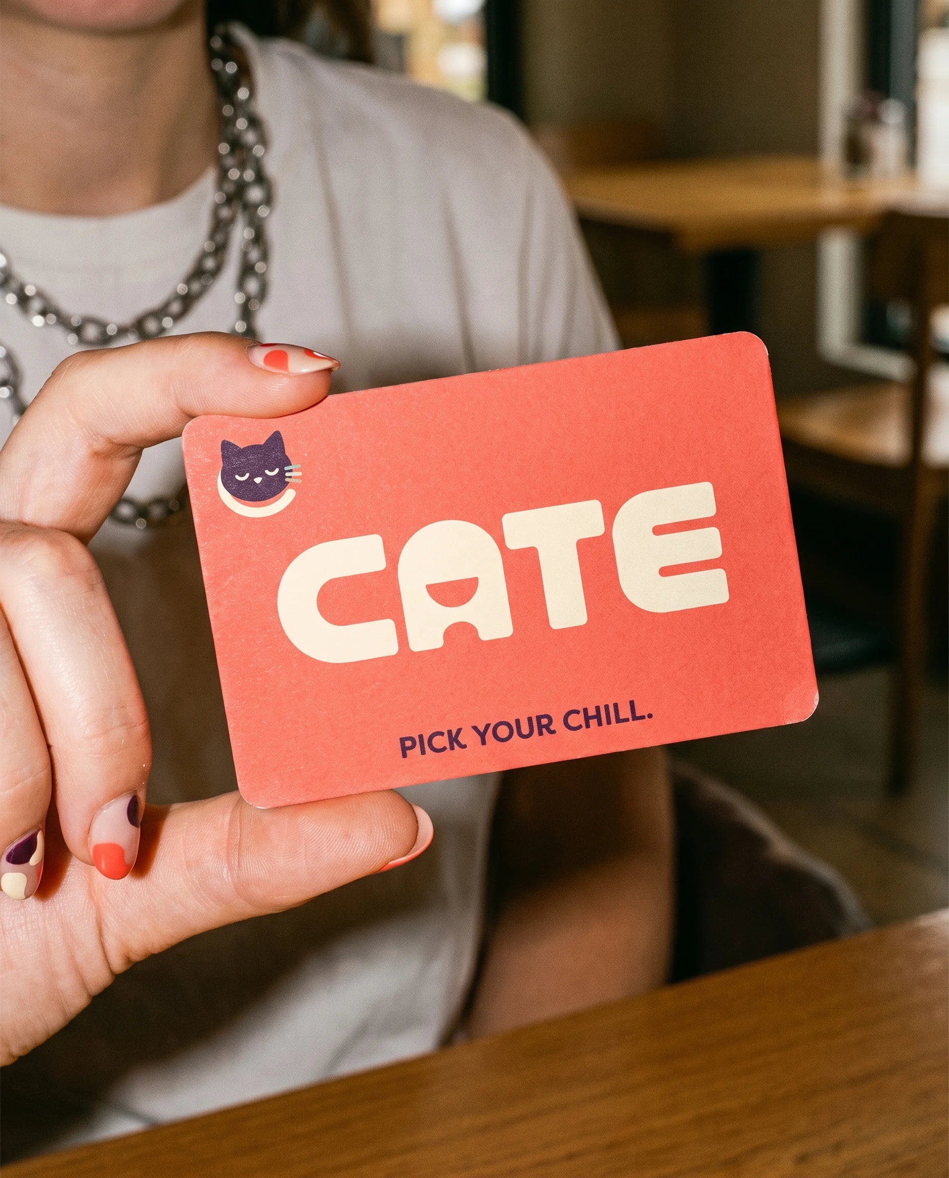 Hand holding a CATE printed card