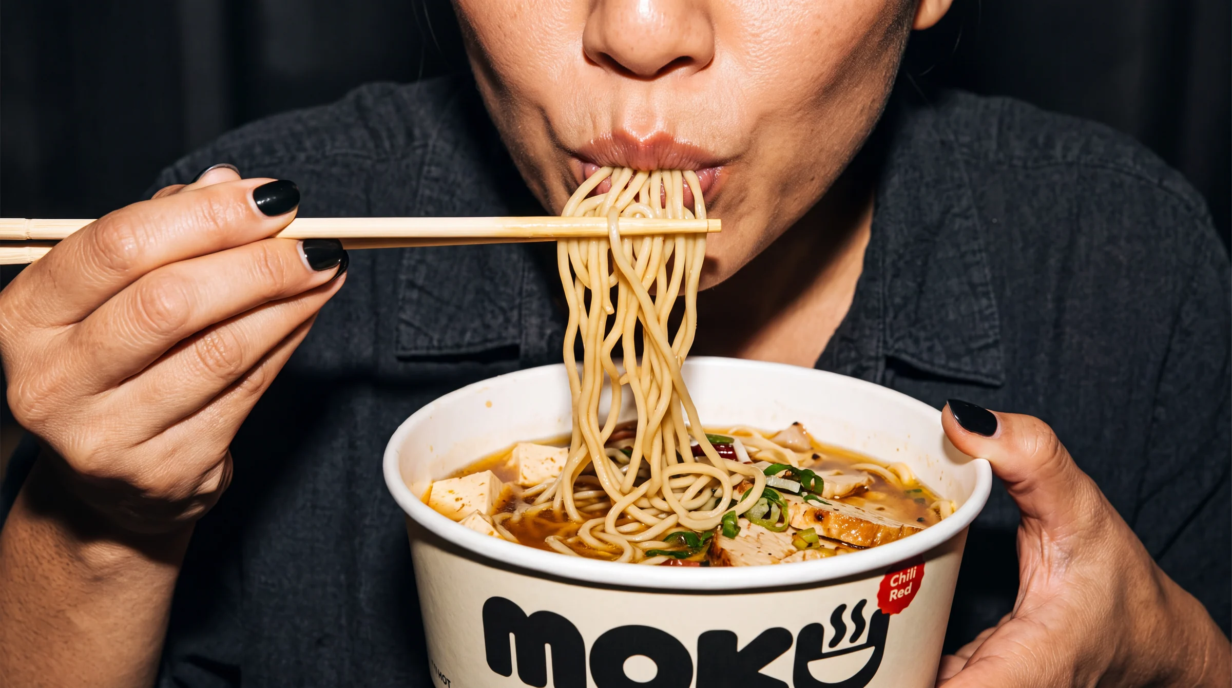 A diner eating noodles in the MOKU visual world